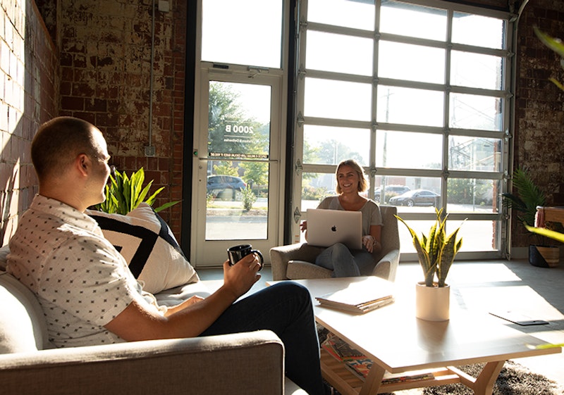 Two People Sitting in an Agency Living Room